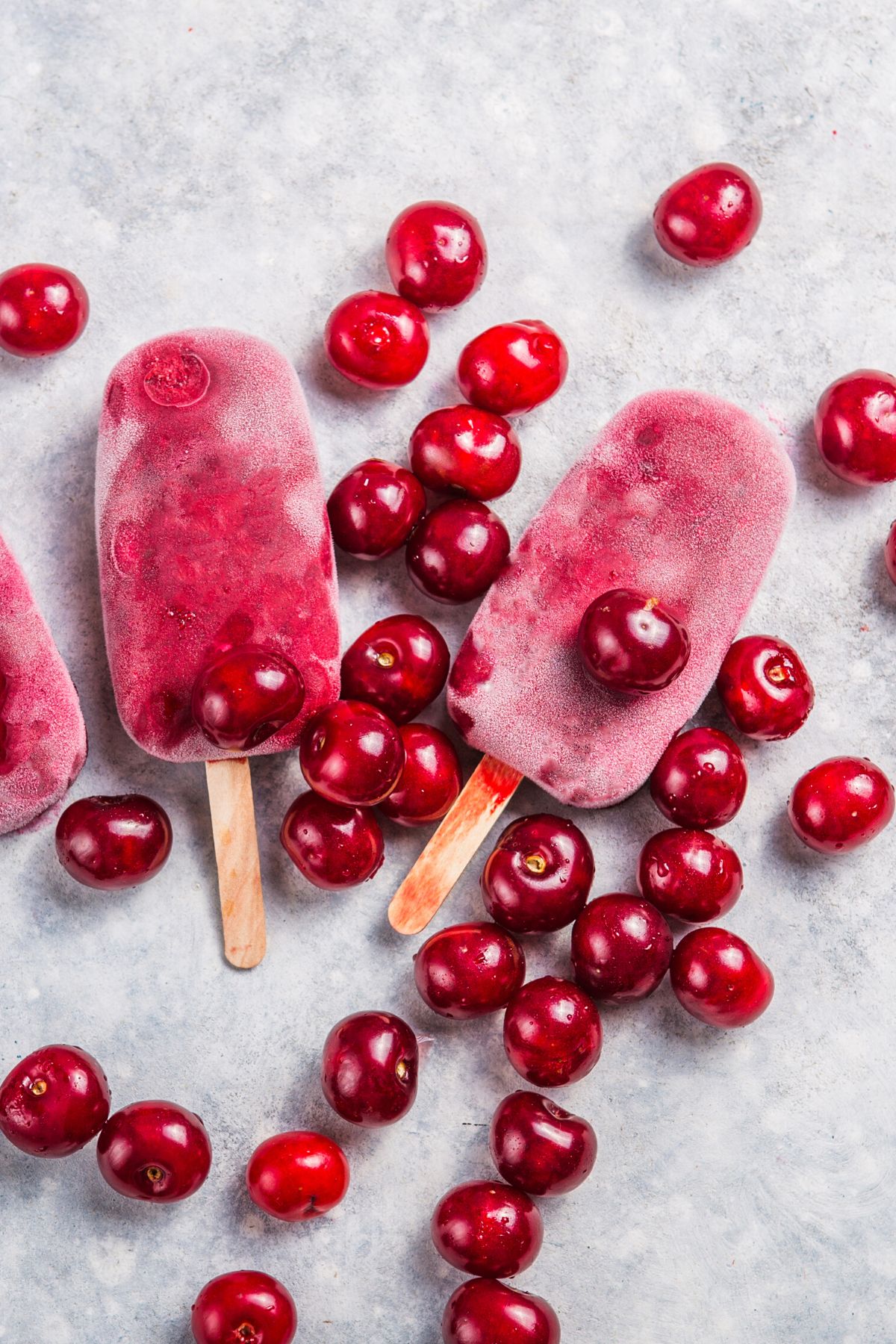 cherry popsicles on table.