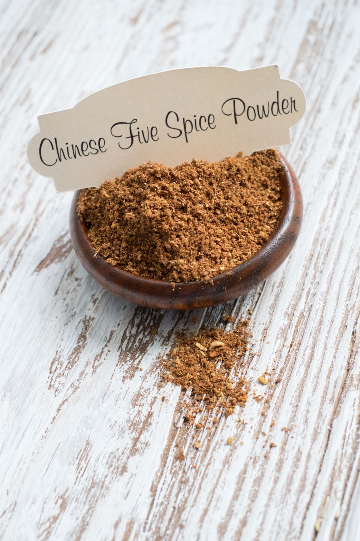 Bowl containing Chinese five spice powder seasoning.