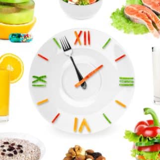 A clock with a fork as a hand surrounded by nuts, vegetables, and salmon.