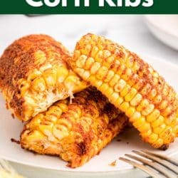 Seasoned air fryer corn ribs on a white plate.