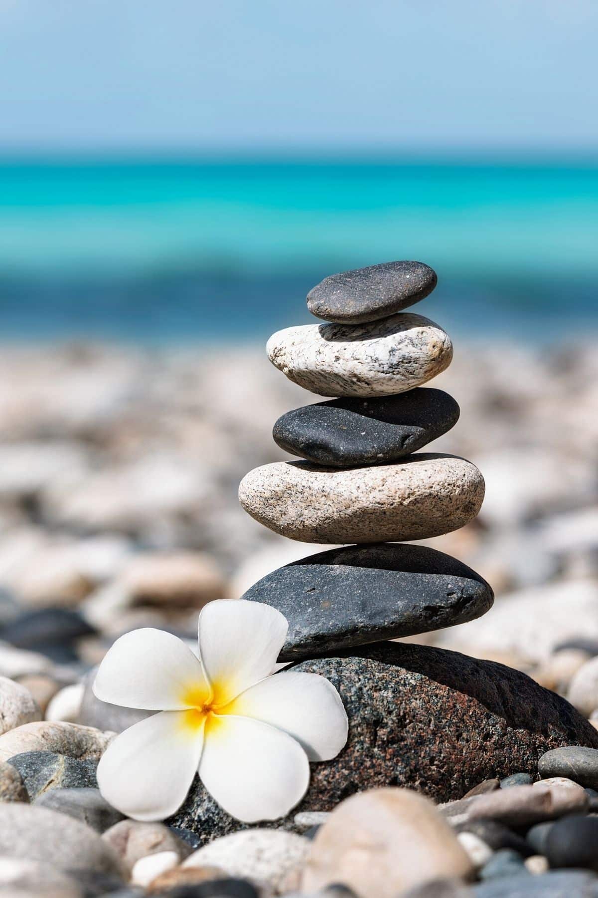 A stack of balanced rocks on a beach to represent balanced hormones.