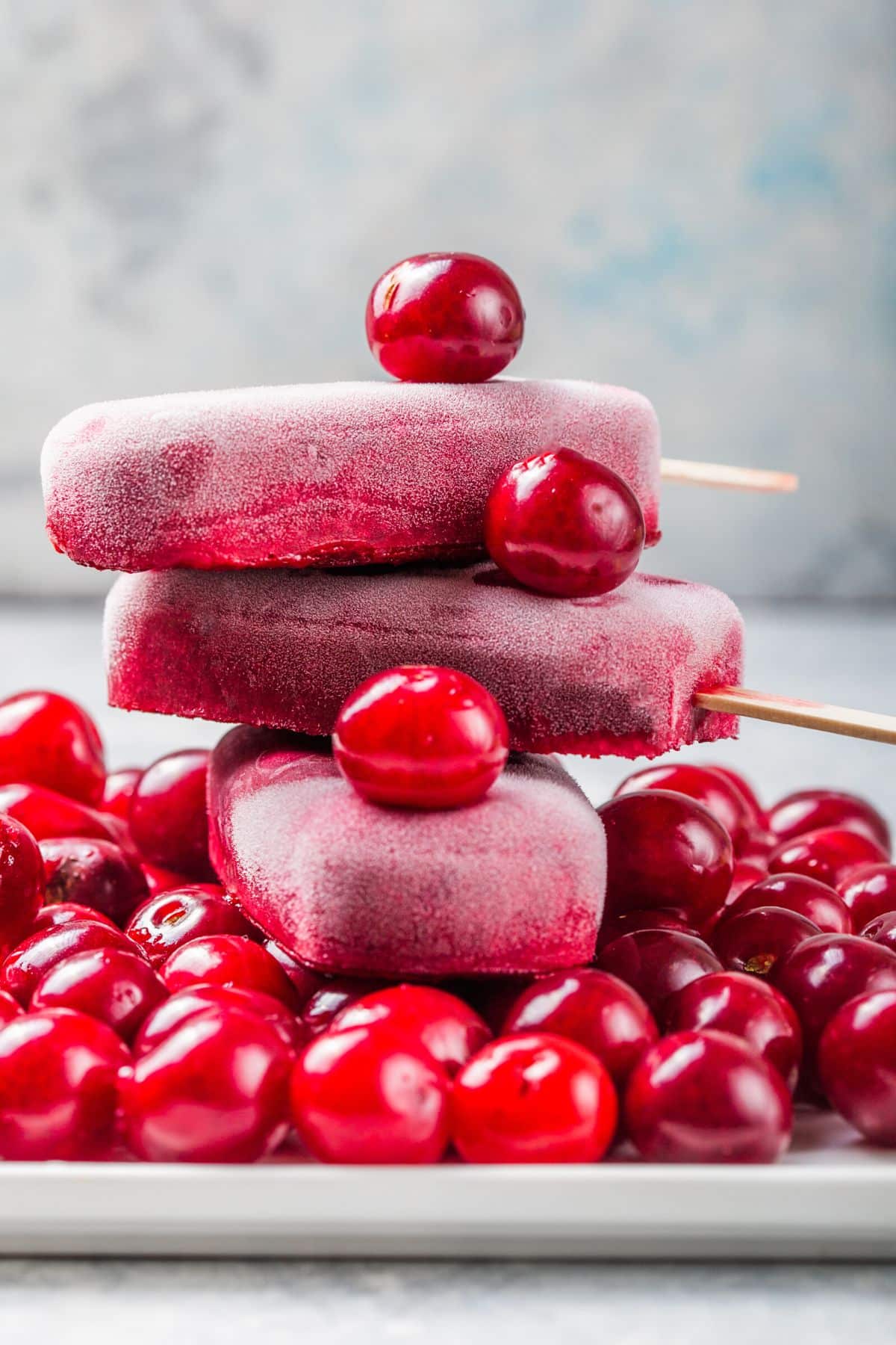 stack of cherry popsicles on a plate.