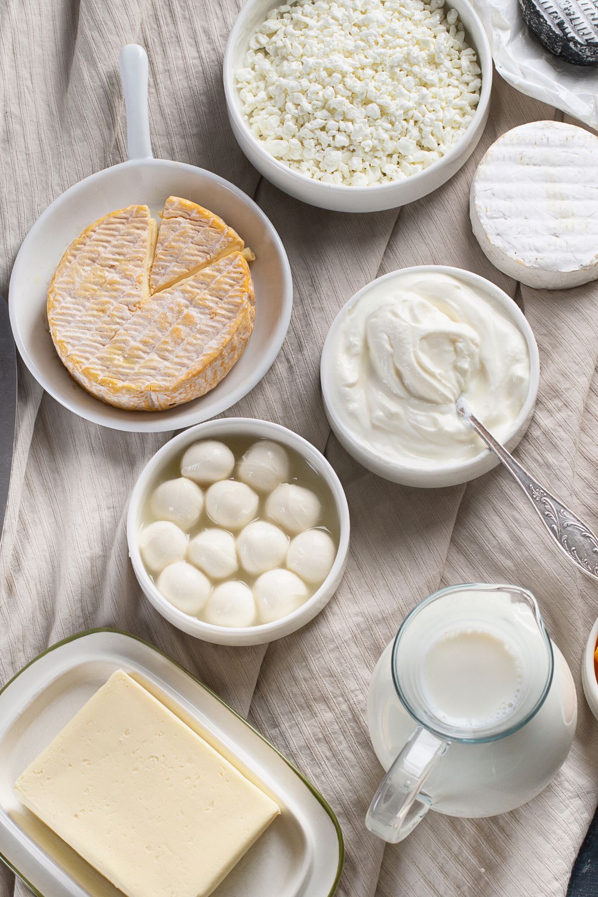 variety of cheese and butter on tabletop.