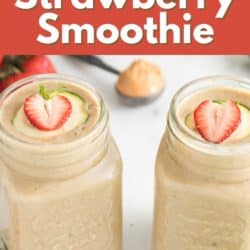 Strawberry zucchini smoothie in a mason jar with strawberries on top.