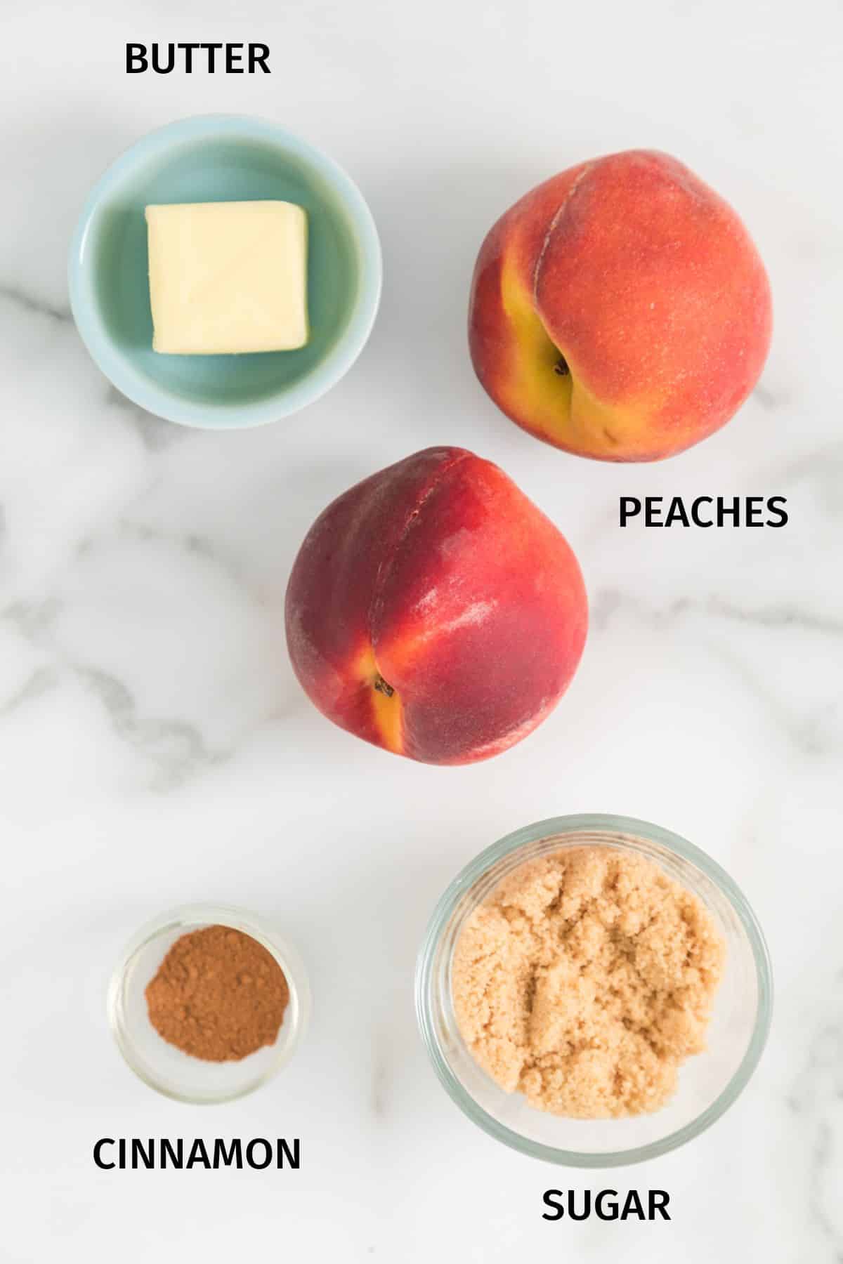 Ingredients to make air fryer peaches on a white surface.