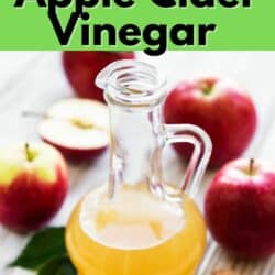 Jar of apple cider vinegar with apples.