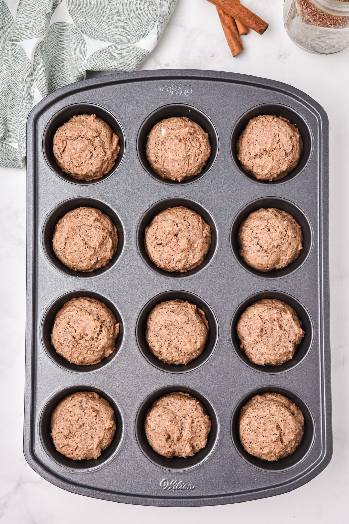 Muffin tray filled with baked flax muffins.