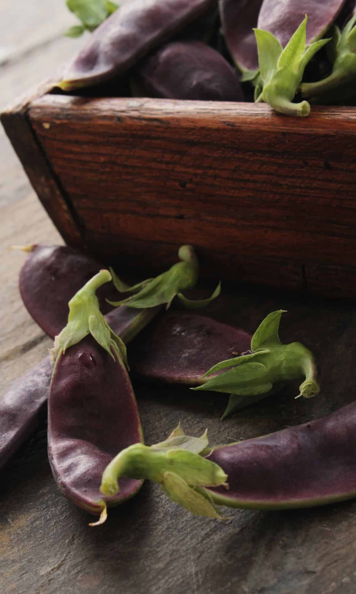 Mangetout vegetable in a wooden bowl.