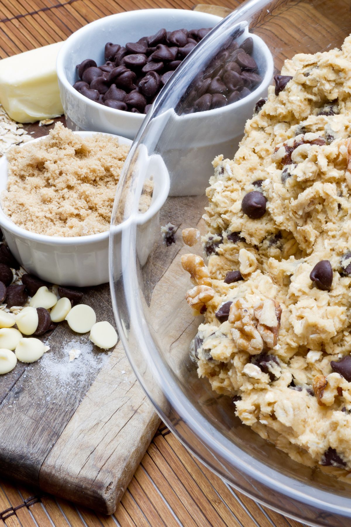 Bowl of chocolate chip cookie dough next to ingredients.