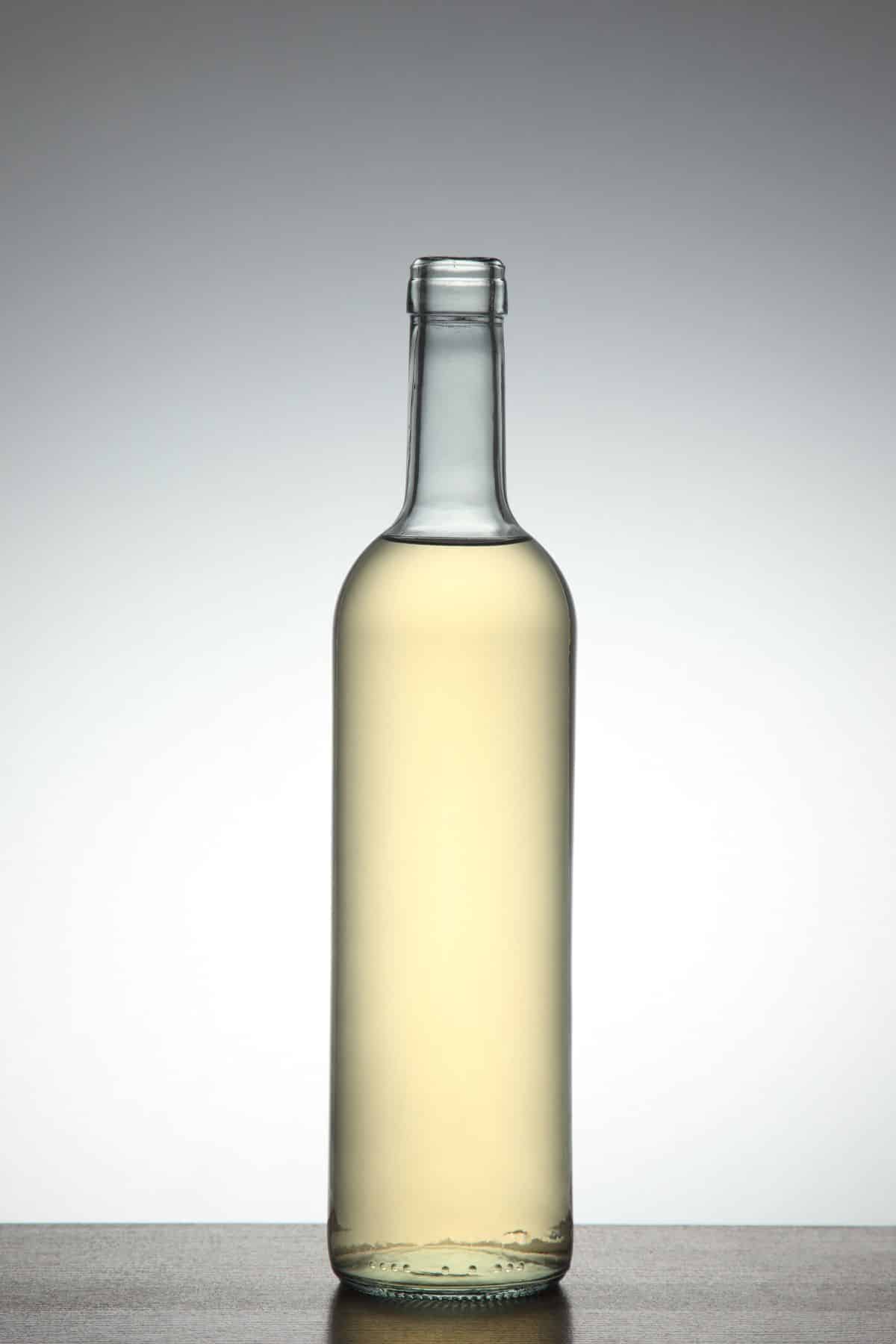 Bottle of champagne vinegar on white background.