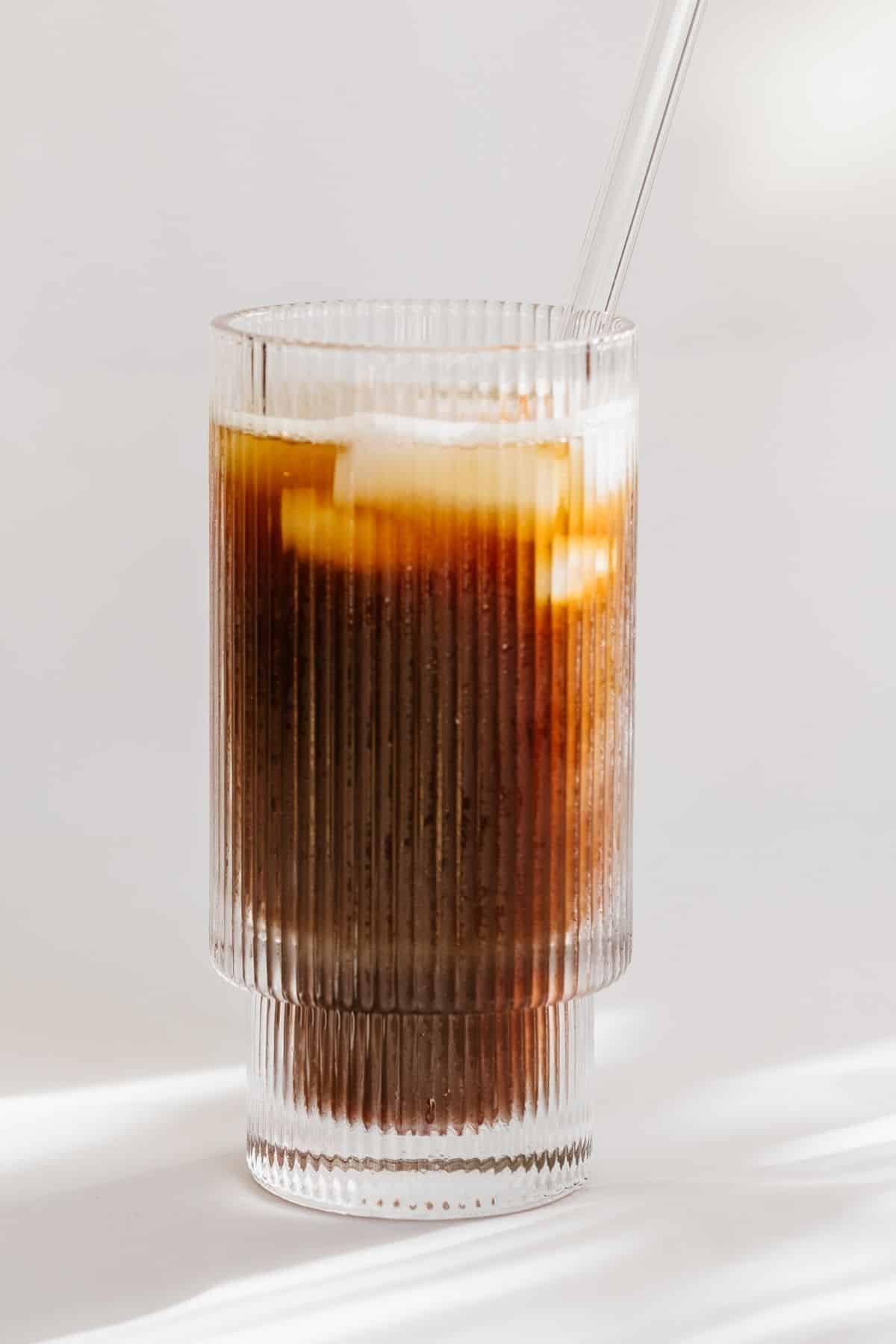 iced americano with glass straw.
