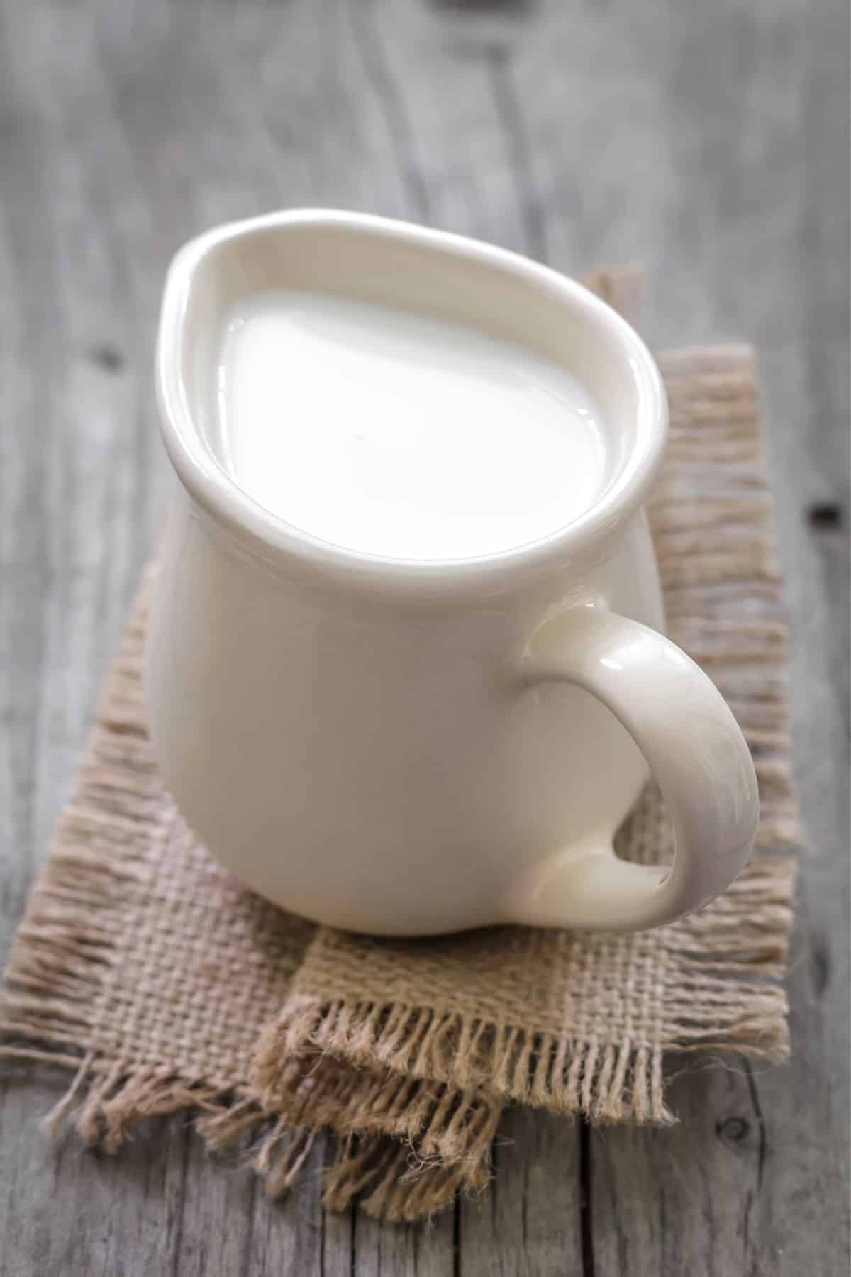 pitcher of cream on a table.