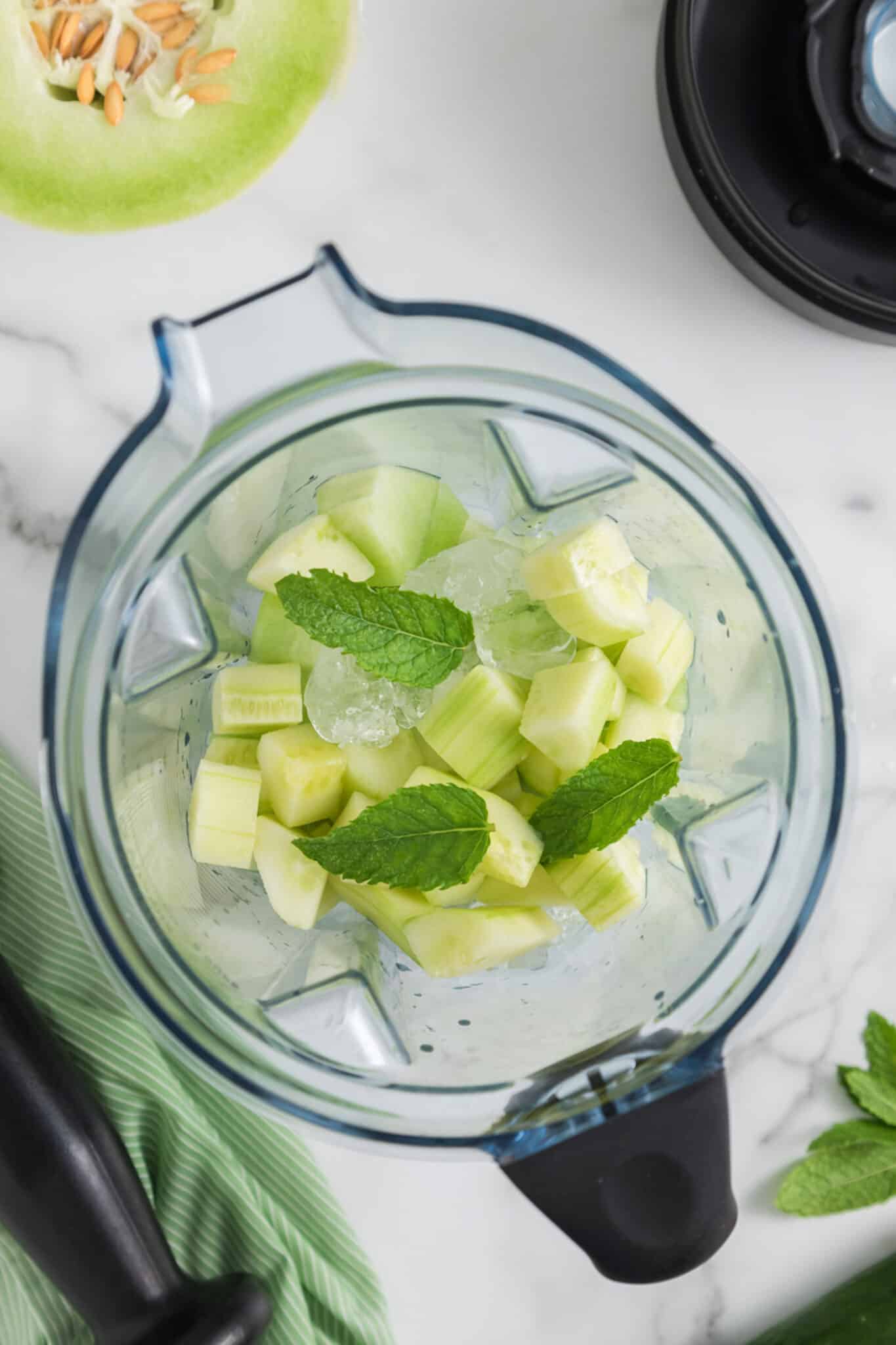 Ingredients for Honeydew Cucumber Smoothie in the jar of a blender.