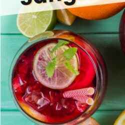 glass filled with virgin sangria mocktail on a table with text.