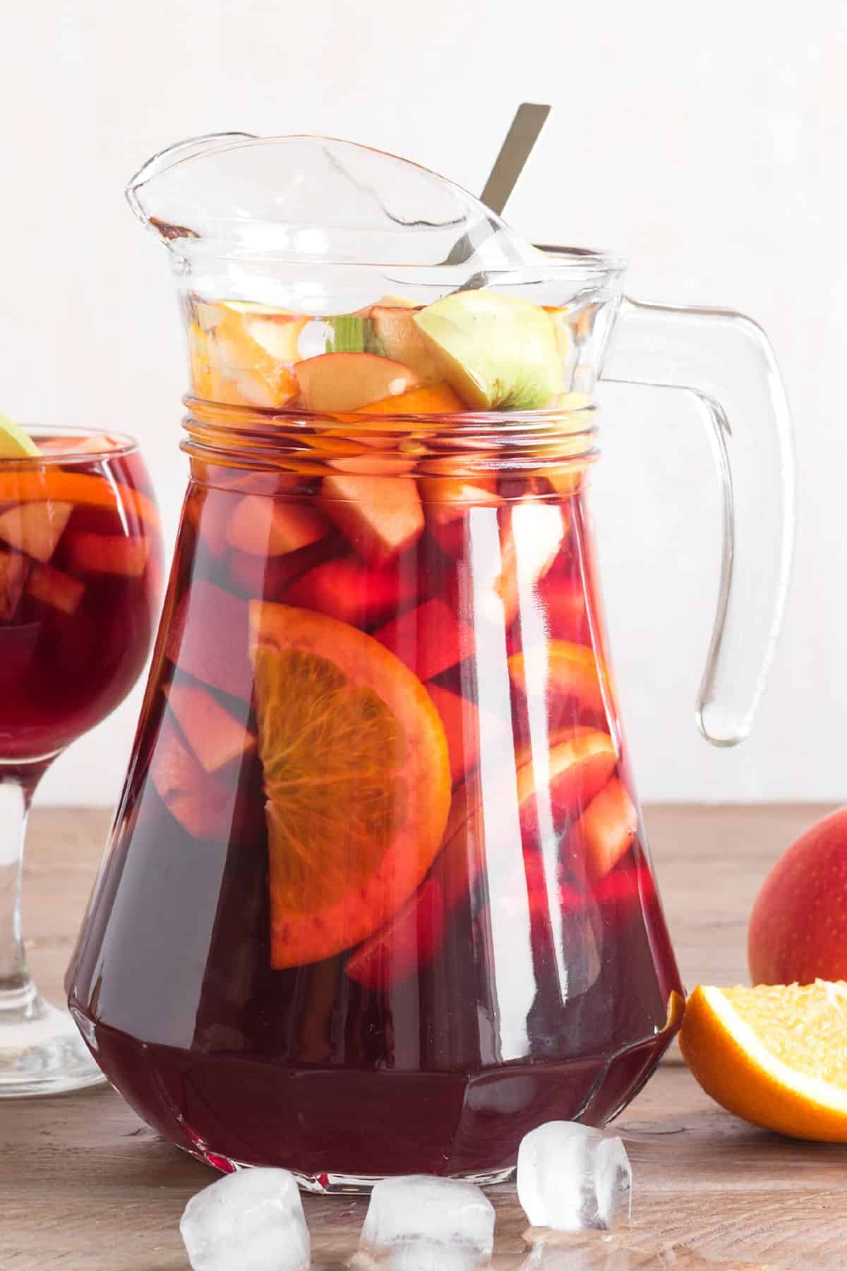 A glass pitcher filled with a virgin sangria mocktail.