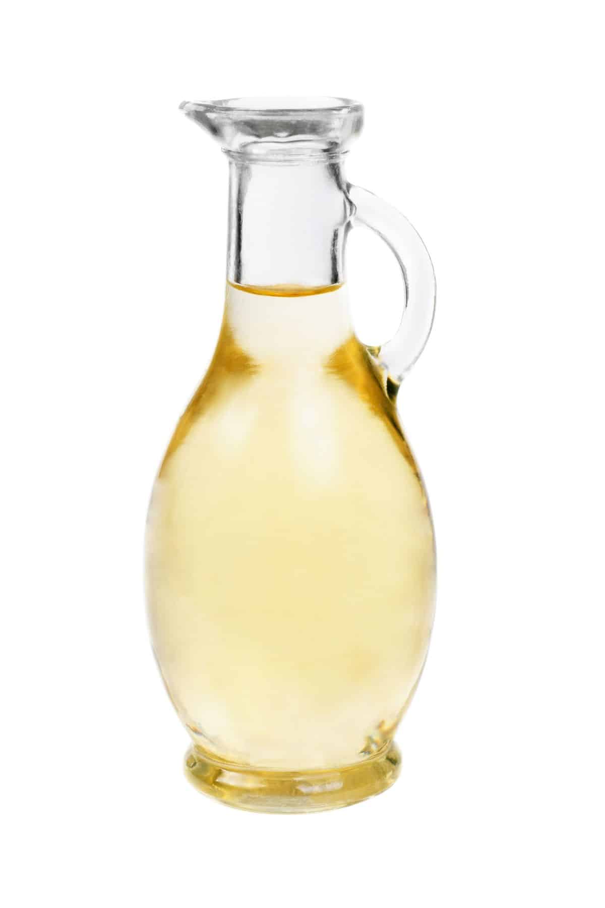 Jar of white wine vinegar on white background.