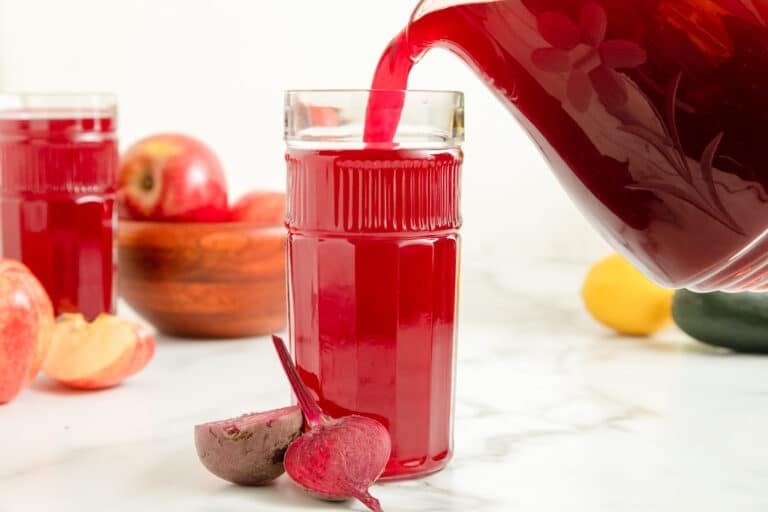 pouring beet juice in glass.