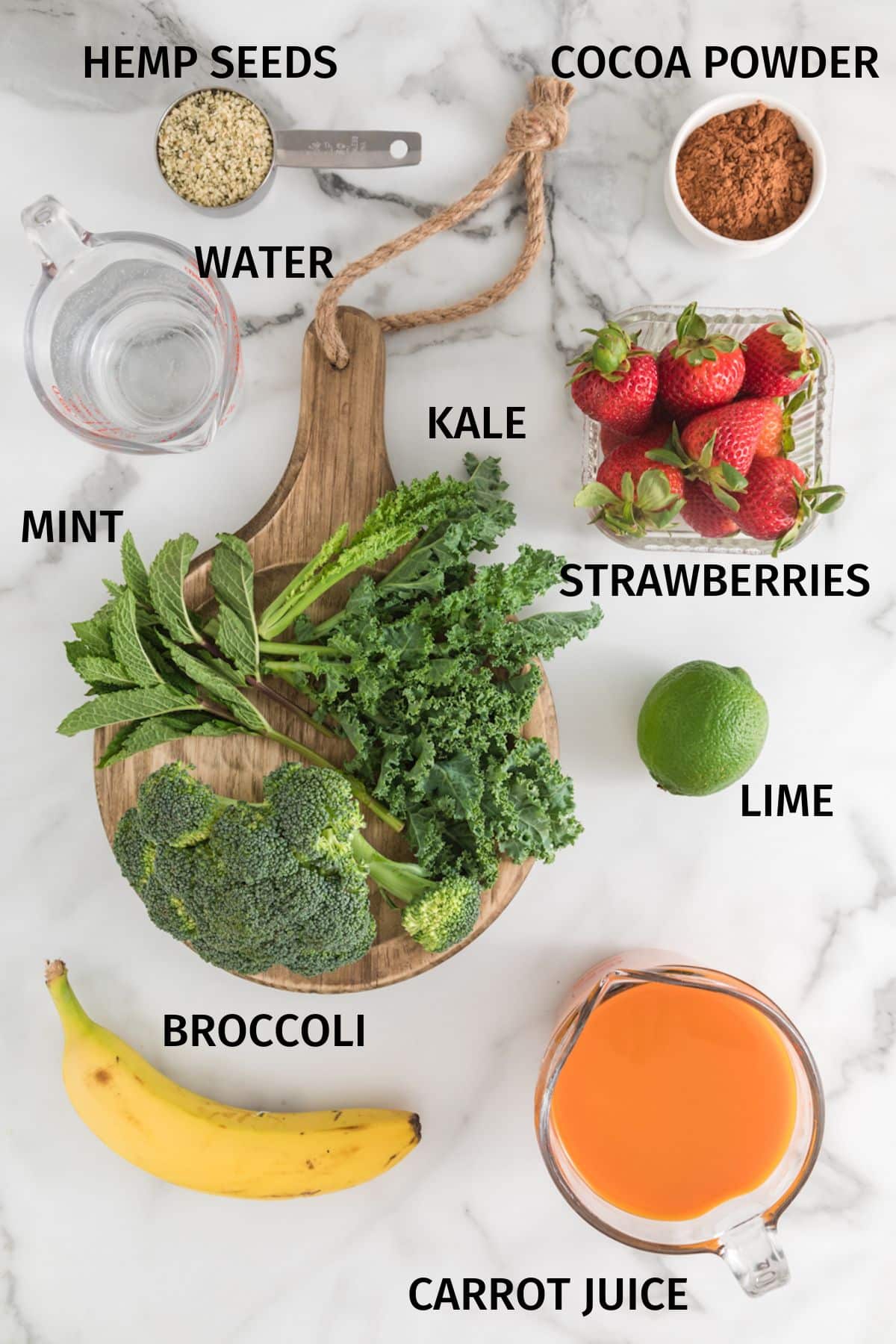Ingredients to make a cancer fighting green smoothie on a white surface.
