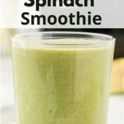 A short glass filled with banana spinach smoothie.