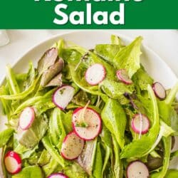 Baby romaine salad with radishes on a white serving platter.
