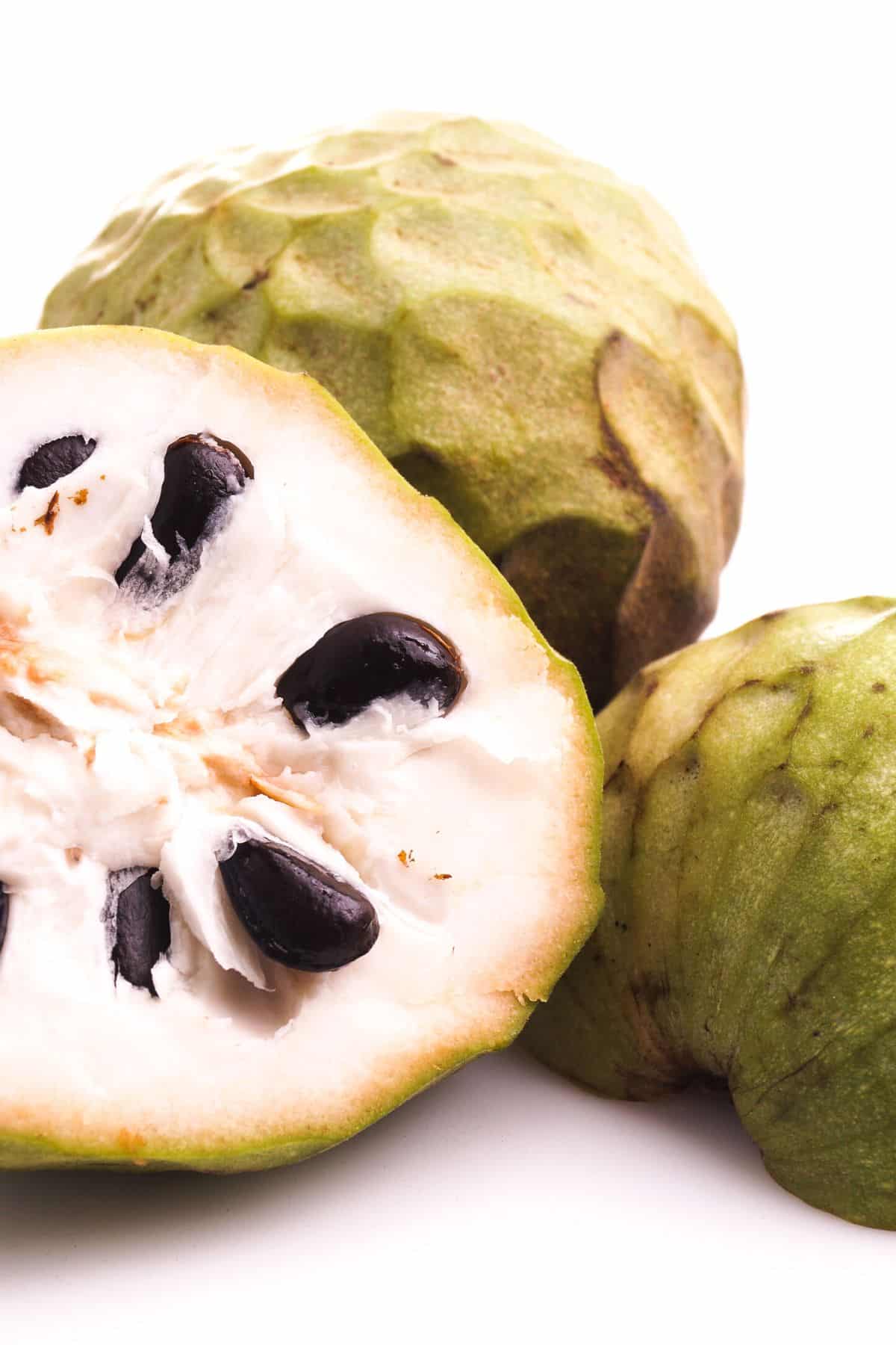 custard apple cut in half on table.