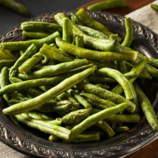 Dehydrated green beans in a metal bowl on the table.