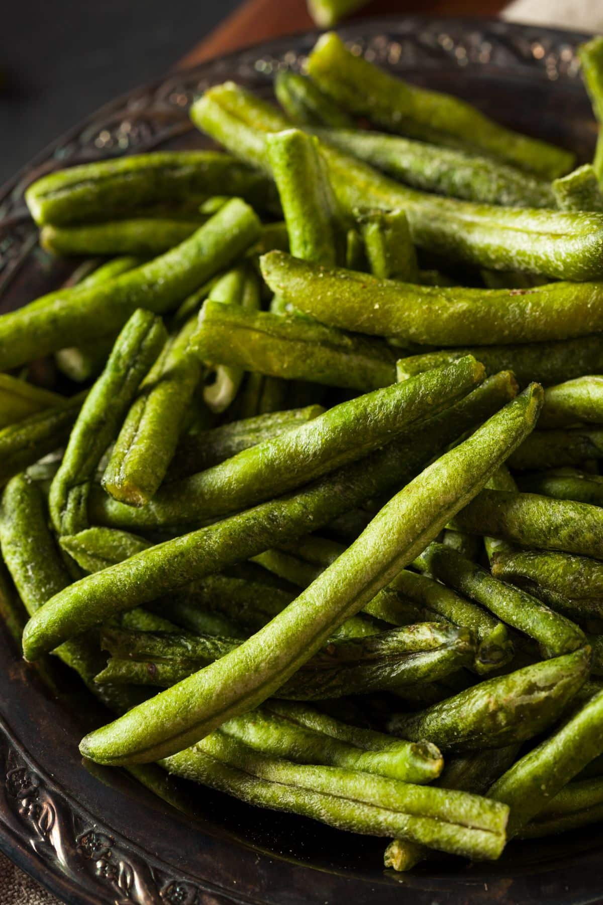 Dehydrated green beans in a metal bowl on the table.