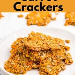 Carrot pulp crackers stacked on a white plate.