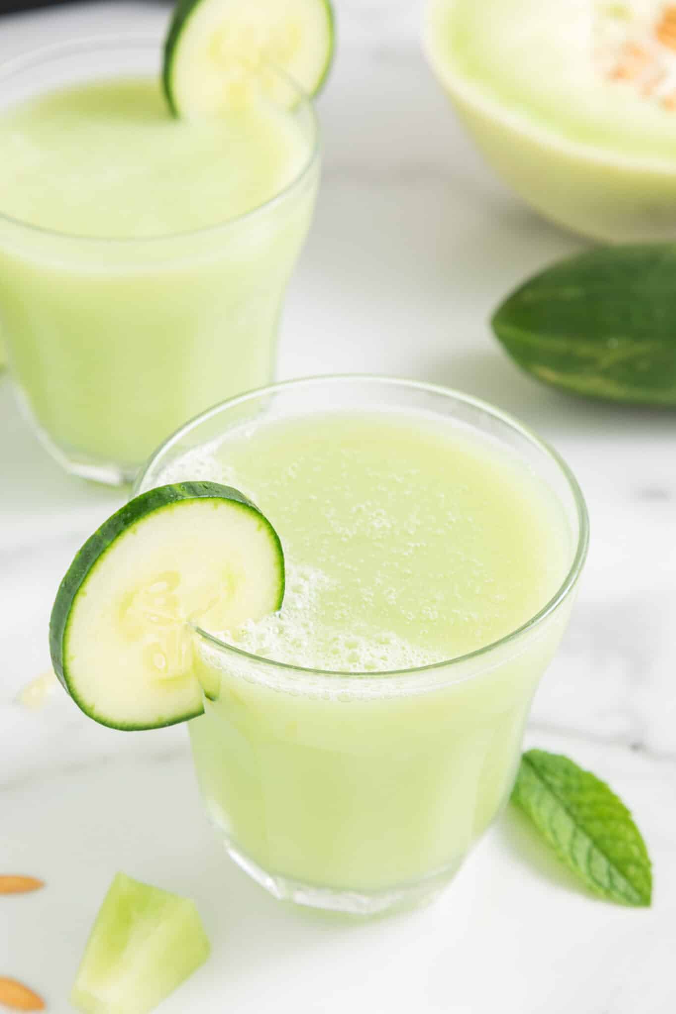two glasses of honeydew cucumber smoothie.