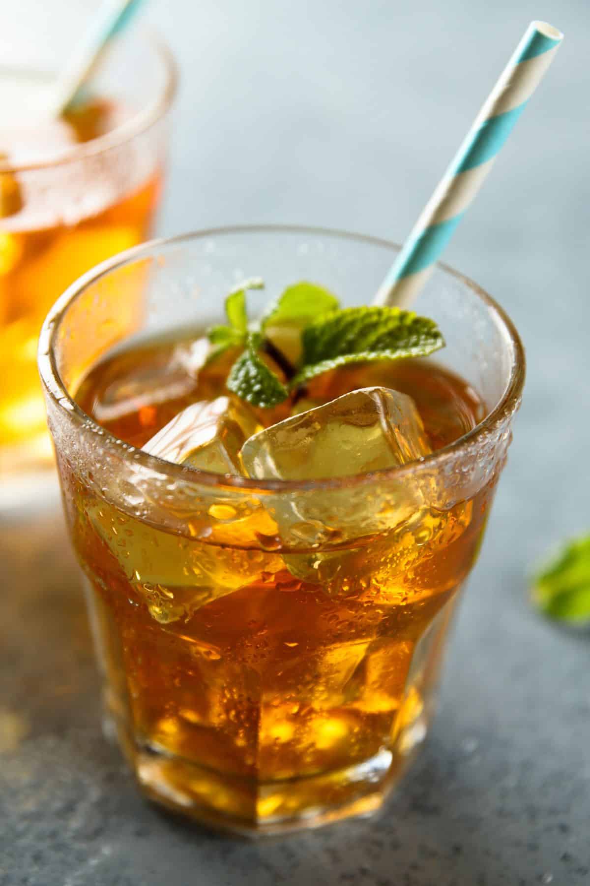 iced mint tea in a glass with a straw.
