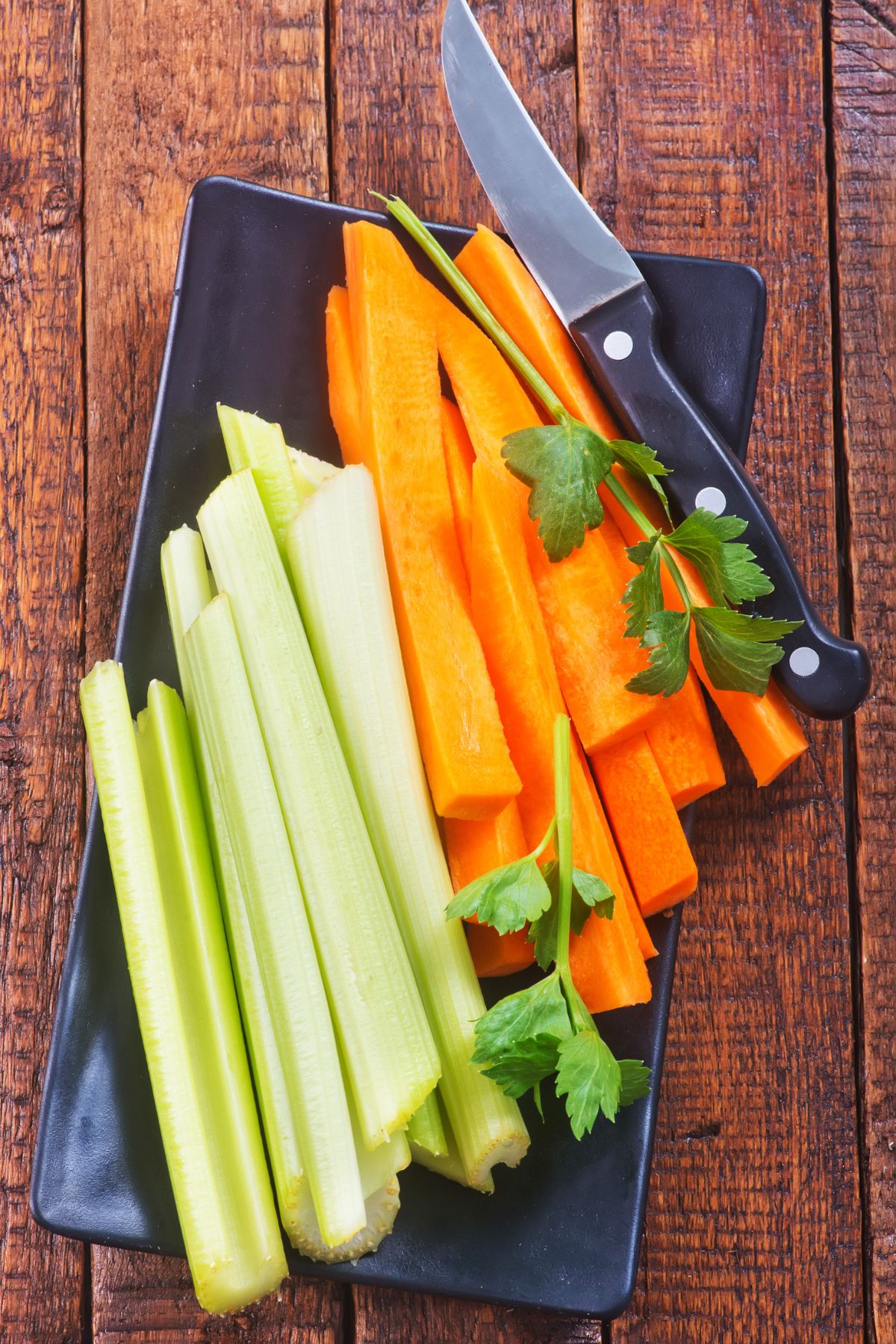 Sliced carrots and celery on a serving plate.