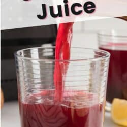 Pouring beet liver cleanse juice into a short glass.