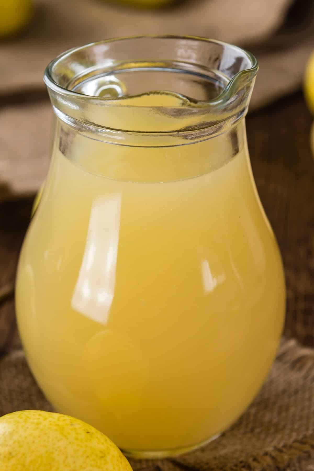 A small pitcher of yellow pear juice.