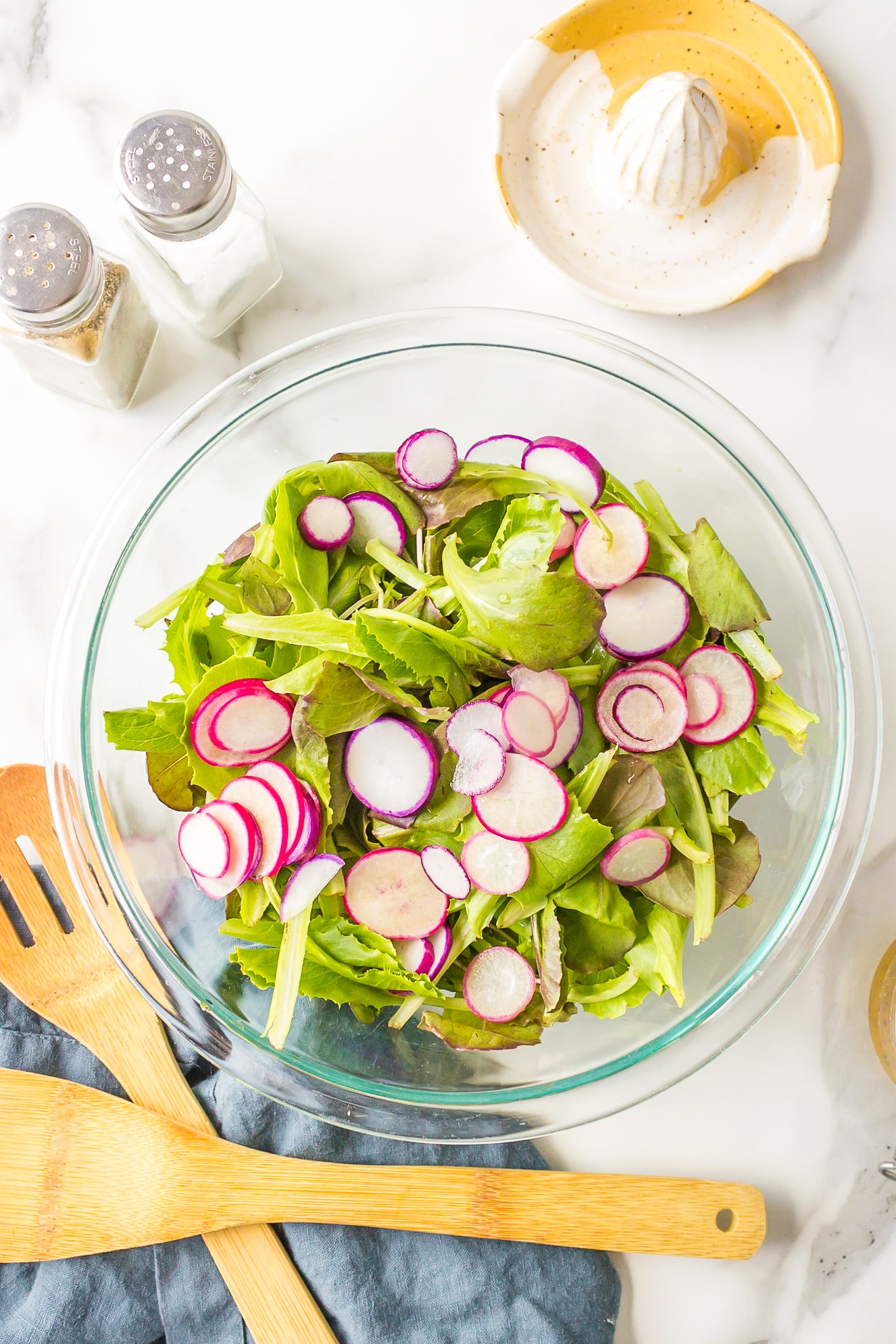 Baby romaine lettuce with radishes in a salad bowl ready to toss.