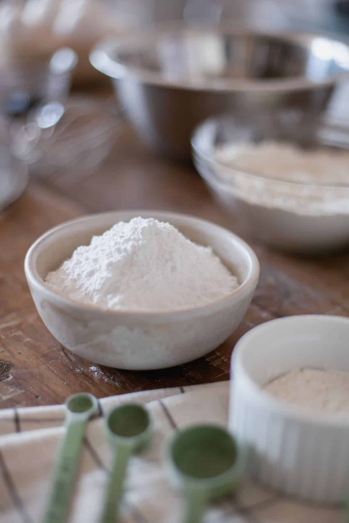 Bowl of Xanthan gum with baking items.