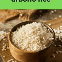 bowl of arborio rice on wooden surface.