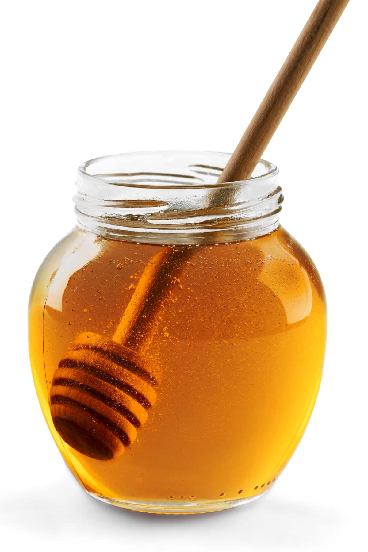Bottle of honey with wooden honey stirrer and white background.