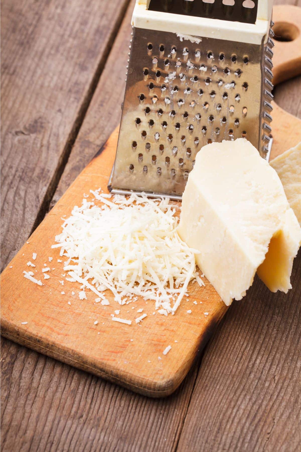 Grated parmesan cheese on wooden surface.