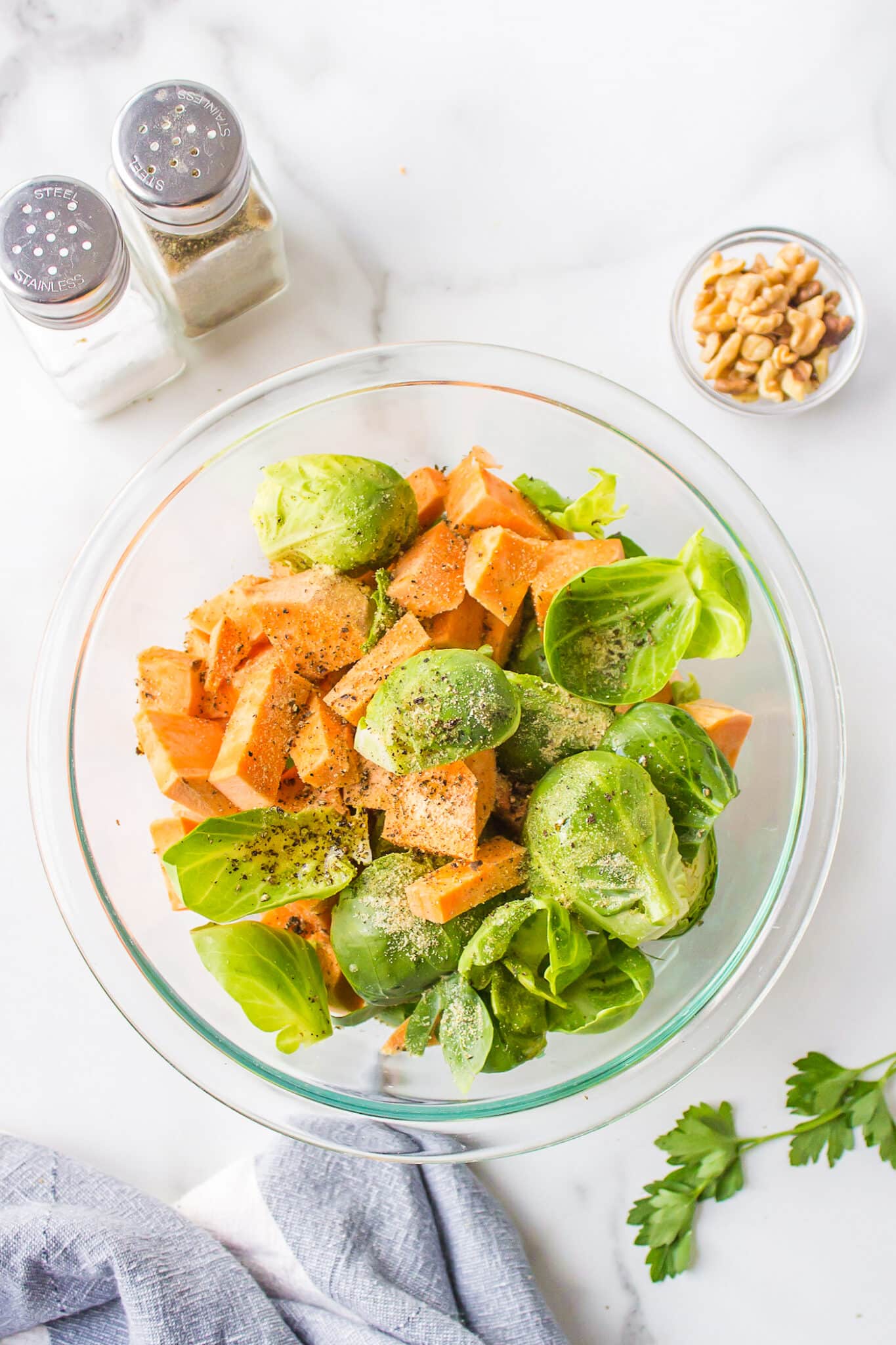 Chopped sweet potatoes and Brussels sprouts in a large mixing bowl.