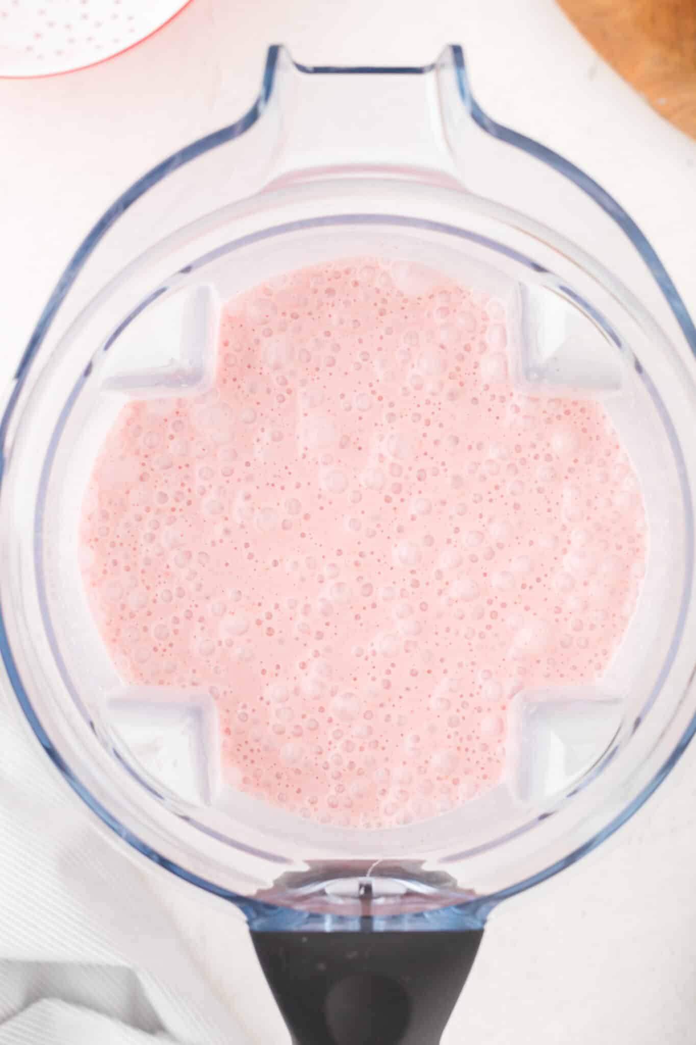 Strawberry smoothie in the jar of a blender.