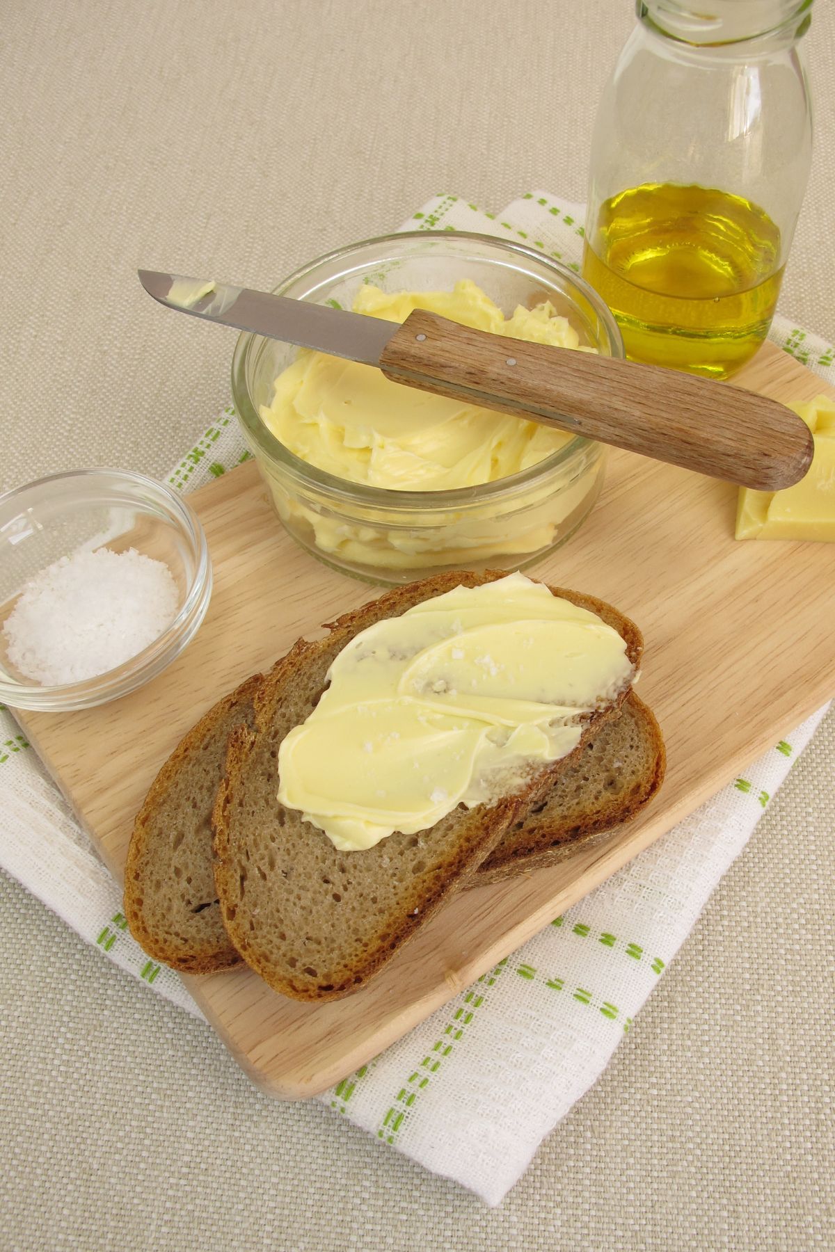Vegan butter spread with toast on cutting board.