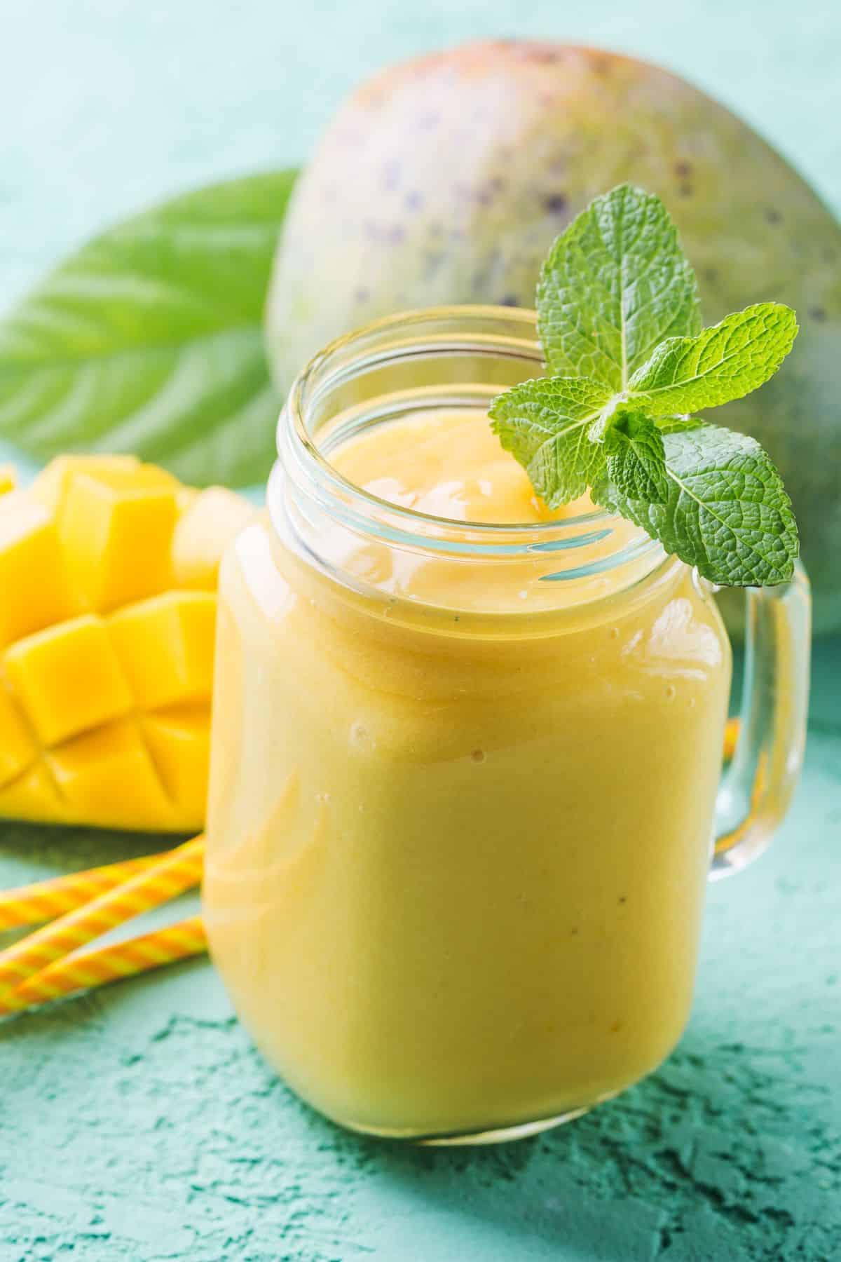 Mango smoothie in a Mason jar.