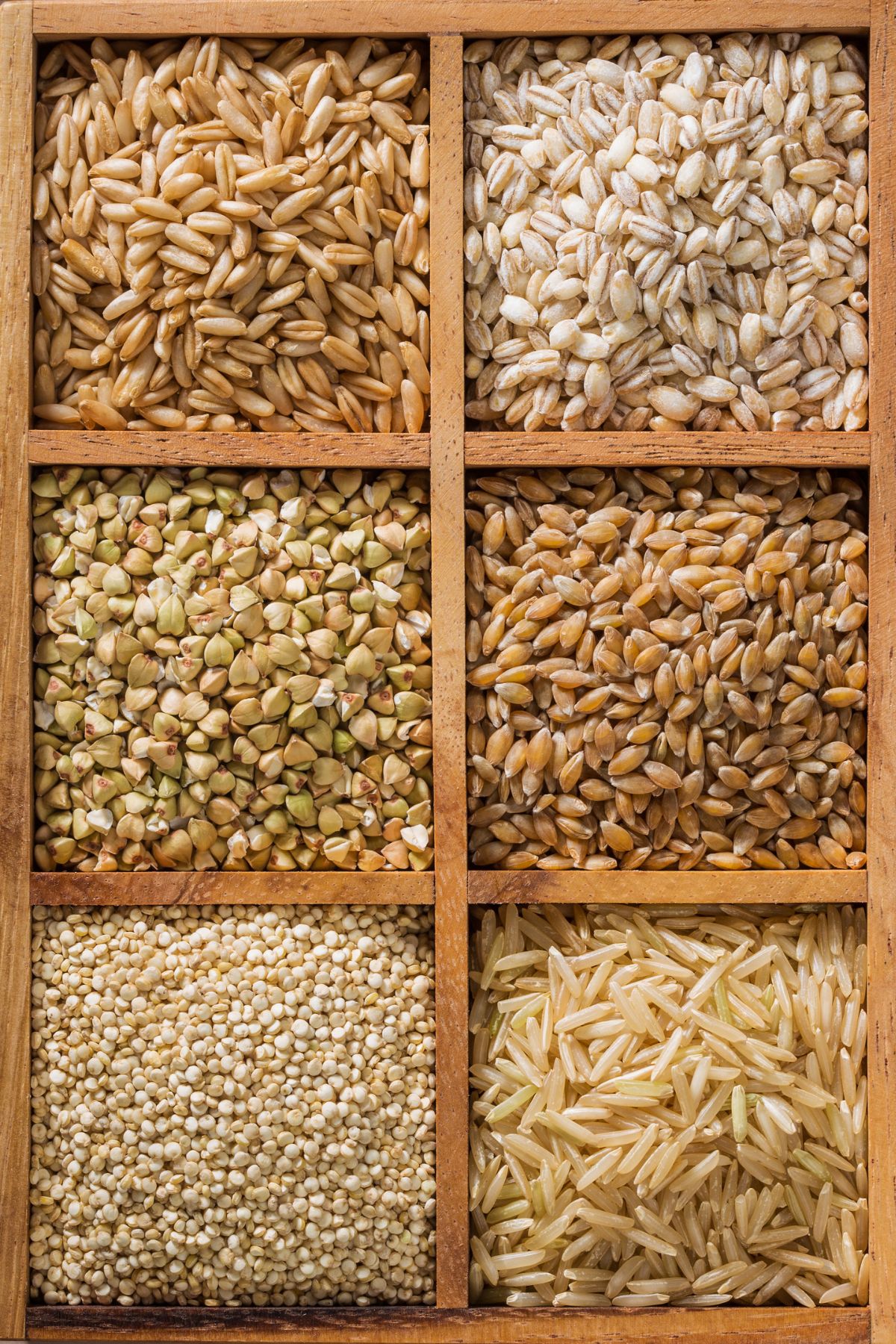 a wooden box containing six types of grains.