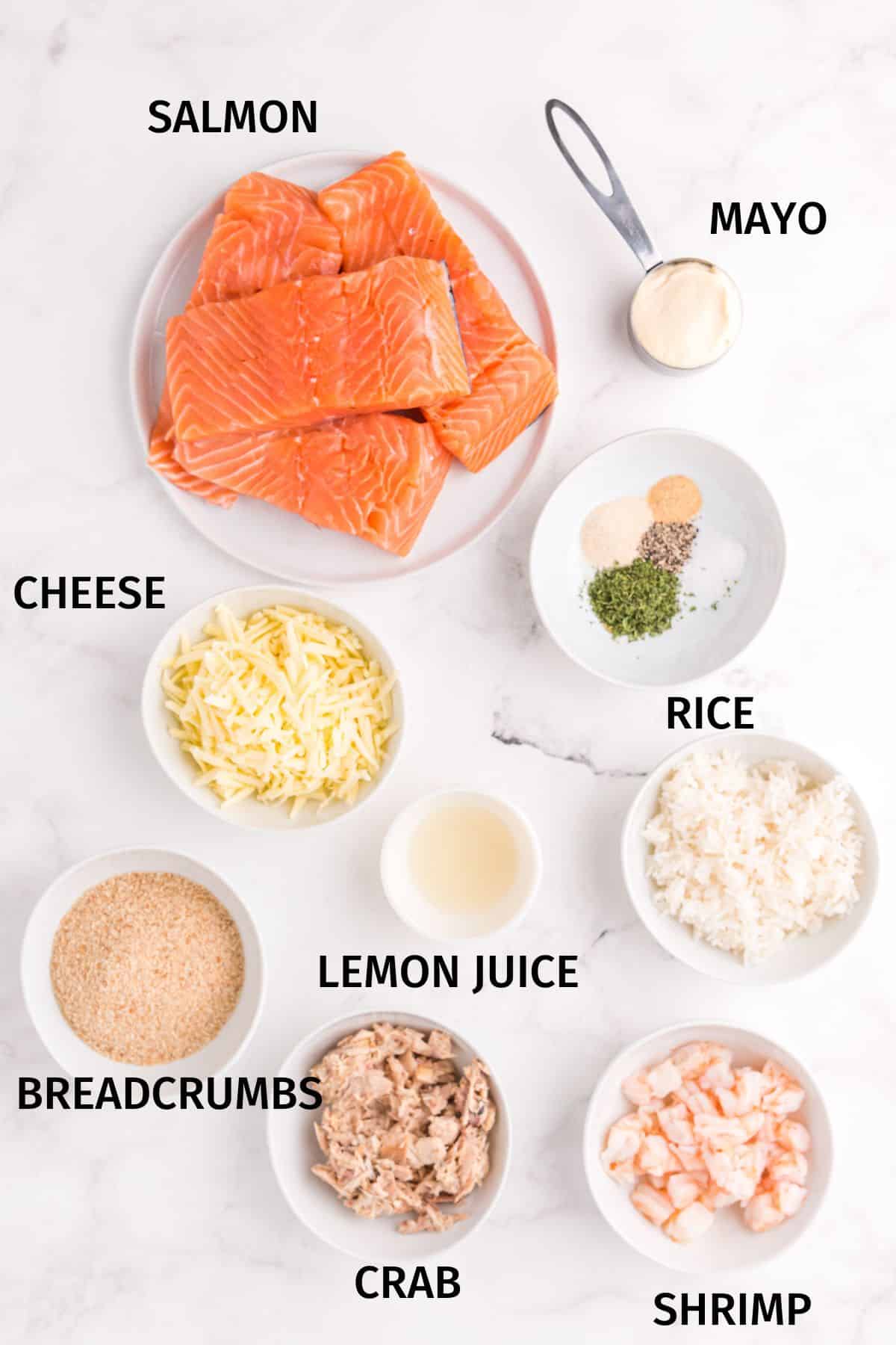 Ingredients to make costco stuffed salmon in small bowls on a white surface.