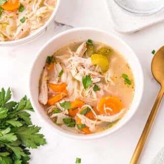 A small white bowl filled with homemade turkey vegetable soup.