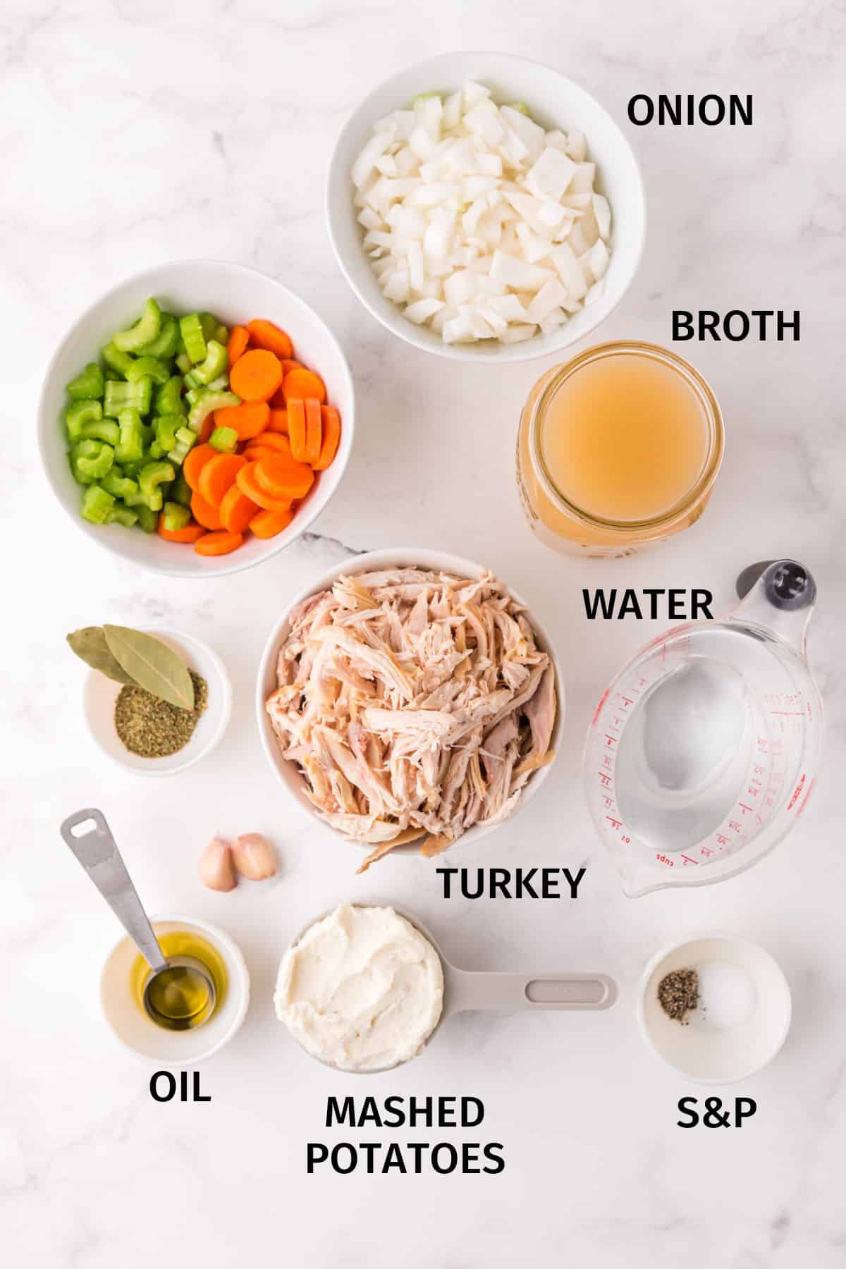 Ingredients to make Instant Pot turkey soup in small bowls on a white surface.