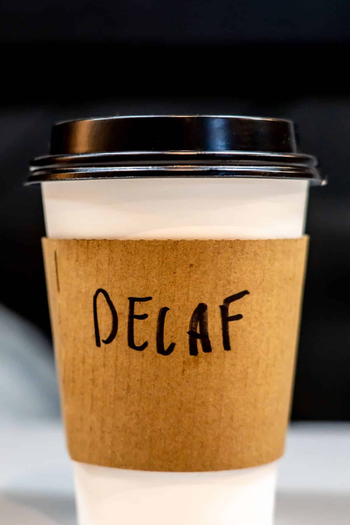 a cup of coffee labeled "decaf."