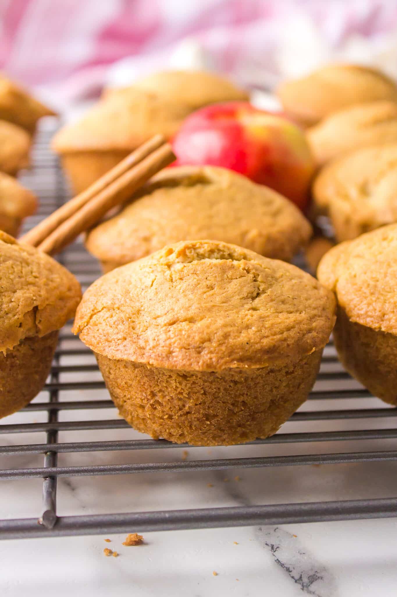 Gluten free apple muffins on a wire rack.