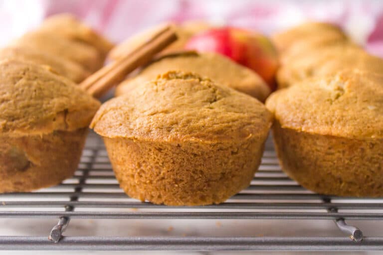 Gluten free apple muffins on a wire rack.