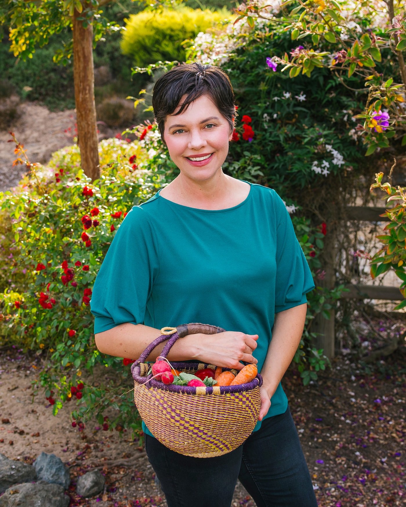 carrie in garden with veggie basket.